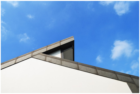 Close up view of the roof and wall under the blue skyの写真素材