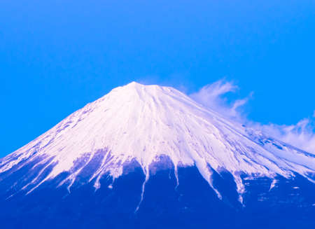 The summit of the holy Mount Fuji covered white snowの写真素材