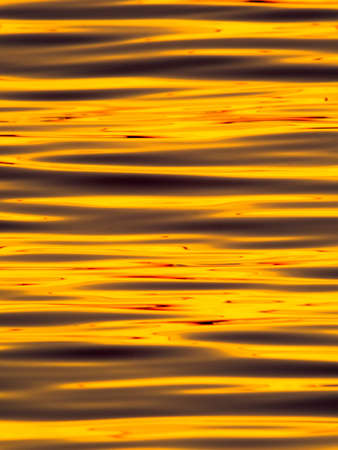 Wavelets on the surface of sunset lake の写真素材