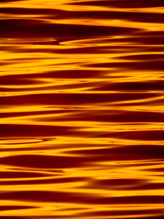 Wavelets on the surface of sunset lakeの写真素材