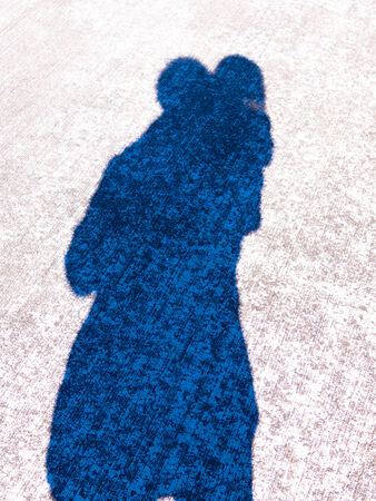 Shadow of piggyback, riding on shouldersの写真素材