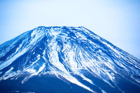 The top of Mount Fuji covered in snowの写真素材