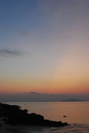 Sunset beach with smile moonの写真素材
