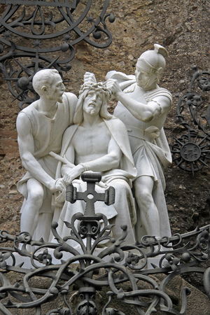 Laying the crown of thorns on Jesus' head, statue near Benedictine abbey Santa Maria de Montserrat in Monistrol de Montserrat, Spainの写真素材