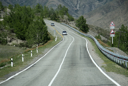 SIBERIA, RUSSIA - JUNE 10, 2012: Cars on the Russian route M52 R256, also known as Chuya Highway or Chuysky Trakt from Novosibirsk to Russia's border with Mongoliaのeditorial素材