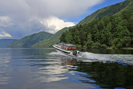 ALTAI, RUSSIA - JUNE 13, 2013: Powerboat on Teletskoye Lake, Altai mountainsのeditorial素材