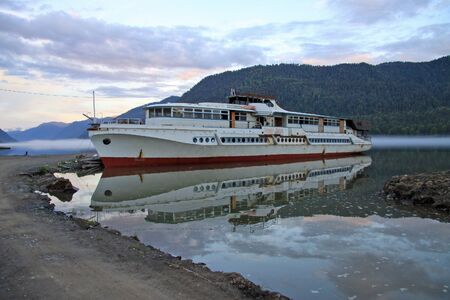 ALTAI, RUSSIA - JUNE 13, 2013: Old boat on Teletskoye Lake in Altai mountains, Russiaのeditorial素材
