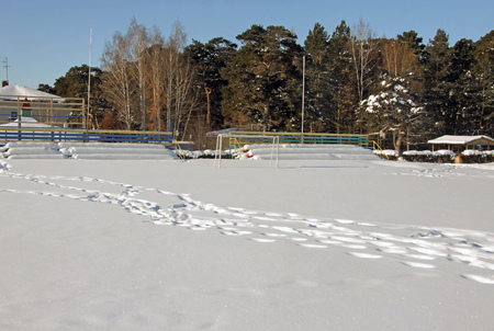 Rustic football field covered by snowの写真素材
