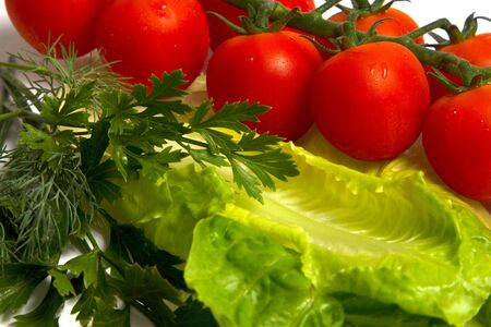 Closeup raw vegetables on cutting board on white backgroundの写真素材