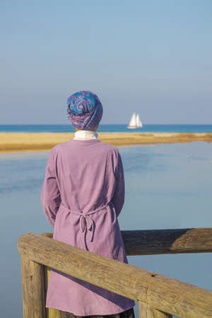 girl watching on yachts in the mediterranean seaの写真素材