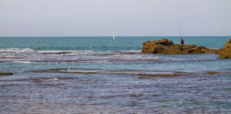 waves and rocks on the Shores of the Mediterranean Seaの写真素材