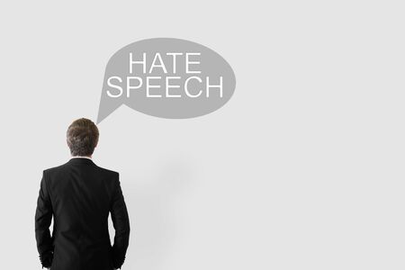 Hate Speech concept. a man with his back to the camera and a cloud of thoughts with the words Hate...