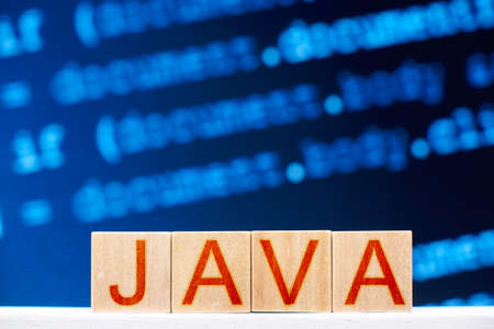 java concept. wooden blocks with java inscription and program code on the background