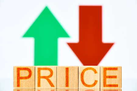 price concept. wooden blocks with the inscription price and arrows up and down on the backgroundの写真素材