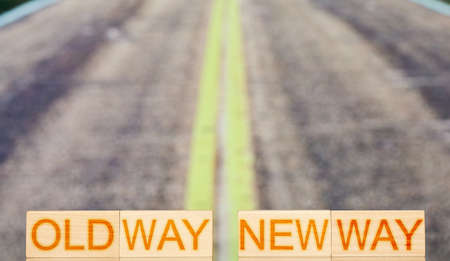 old way new way. wooden blocks with the inscription old way new way on the background of road...