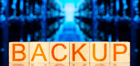 backup. wooden blocks with backup lettering on blue background with storage serversの写真素材