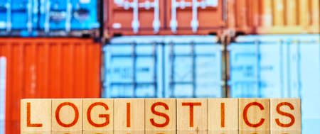 logistics. wooden blocks with the inscription logistics on the background of transport containers