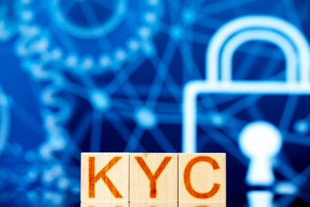 kyc. wooden cubes with the inscription kyc on a blue backgroundの写真素材