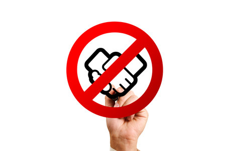 Handshake forbidden. man drawing a stop sign with a handshake insideの写真素材