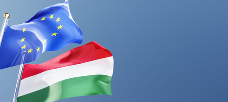 hungary and european union flags waving in the wind against a blue sky mockup with copy space....