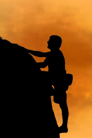 silhouette of free style climber on topの写真素材