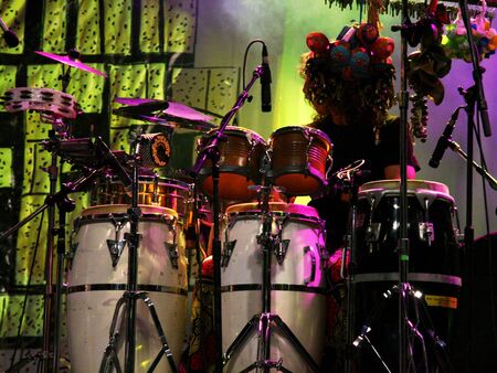 A drummer at a concert with various drums and percussionの写真素材