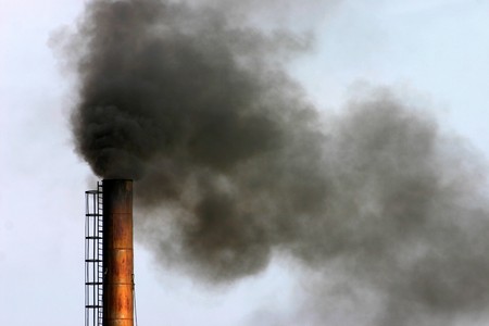 Air pollution - smoke billowing from chimneyの写真素材