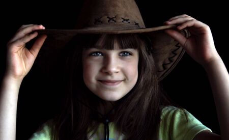 Little girl with cowboy hat on his headの写真素材