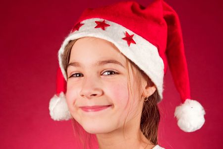 Cute little girl and santa claus hatの写真素材