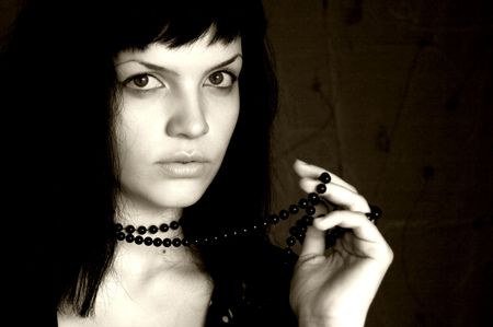 Young girl with a necklace, black backgroundの写真素材