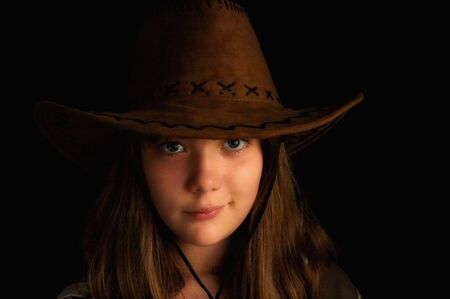 Little girl with cowboy hat on his headの写真素材