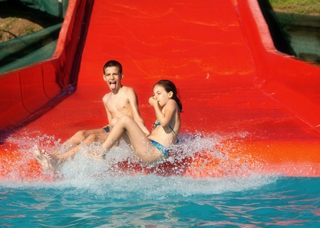children in the red water slideの写真素材