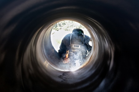 A metalworker welding a metal barrelの写真素材