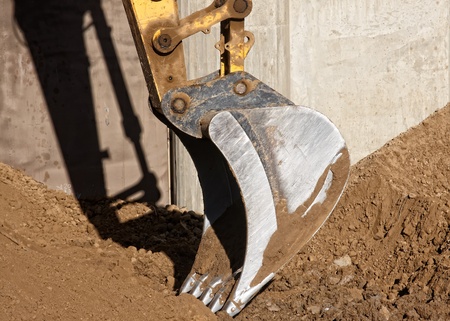 Excavator digging a deep trench