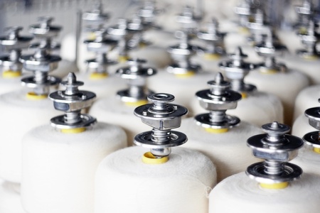 Colorful spools of thread in a textile factoryの写真素材