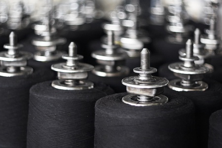 Colorful spools of thread in a textile factoryの写真素材