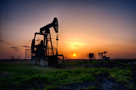 Oil pump, industrial machine for petroleum in the sunset backgroundの写真素材