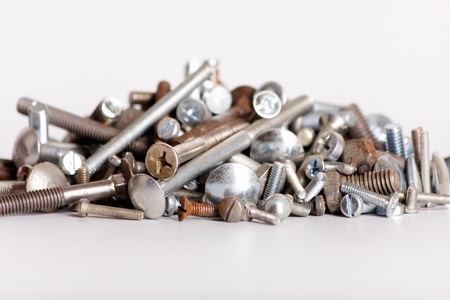 A bunch of different screws on white backgroundの写真素材