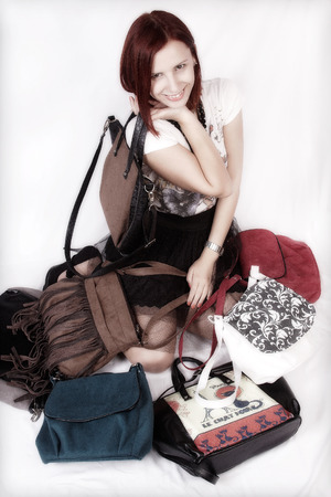young girl lying between the modern purseの写真素材