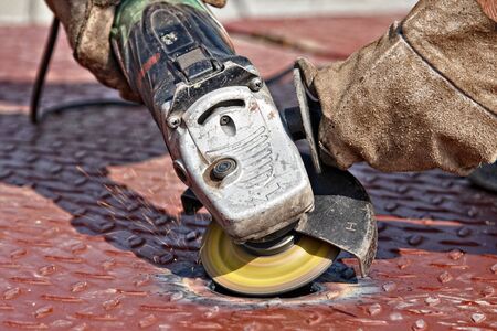 man cutting metal mesh using grindersの写真素材