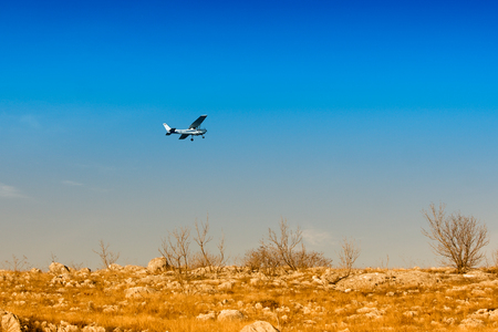 Small turboprop plane against a blue skyの写真素材