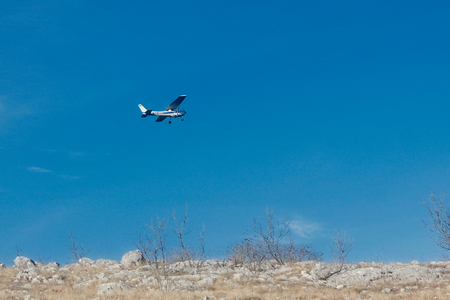 Small turboprop plane against a blue skyの写真素材