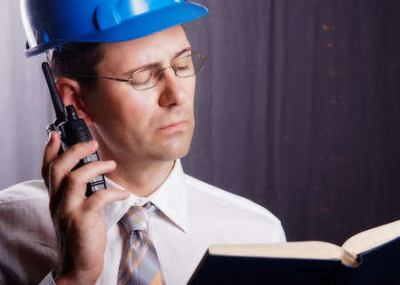 An engineer with a helmet on a construction site communicatesの写真素材