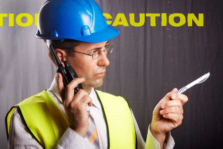 An engineer with a helmet on a construction site communicatesの写真素材
