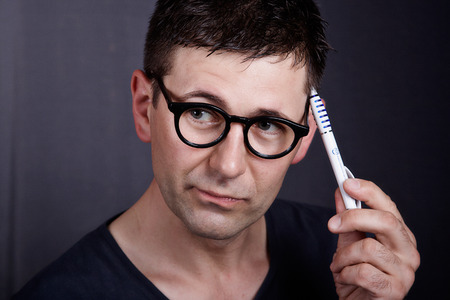 Portrait of young men with glasses while thinkingの写真素材