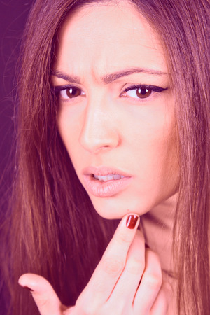 Young beautiful woman looking pimple on her faceの写真素材