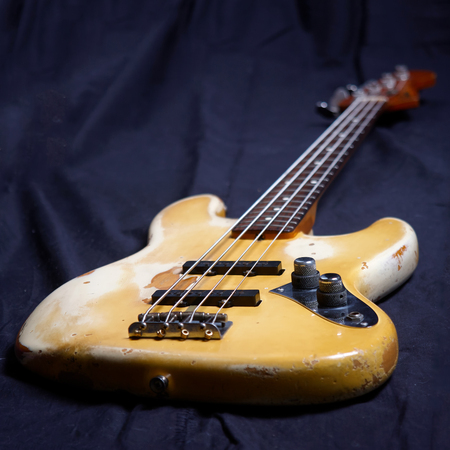 Old electric bass guitar, focus on volume controllerの写真素材