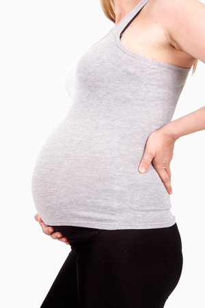 Pregnant woman touching her belly, clipping pathの写真素材