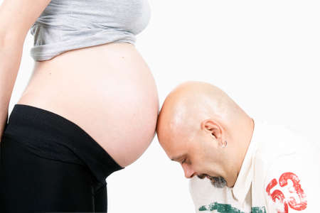 Young pregnant woman with husband in room, clipping pathの写真素材