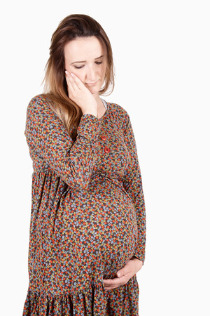 Pregnant woman touching her belly, clipping pathの写真素材